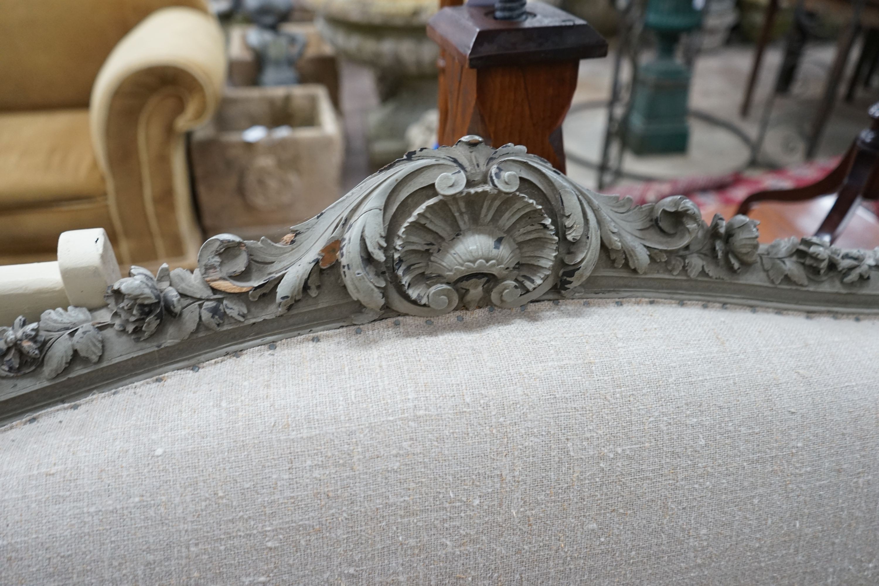 A 19th century French carved wood settee upholstered in a natural linen type fabric, re-painted in grey, length 180cm, depth 60cm, height 102cm